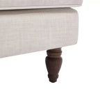 Poltrona in misto lino con braccioli arrotolati e gambe tornite in legno massello